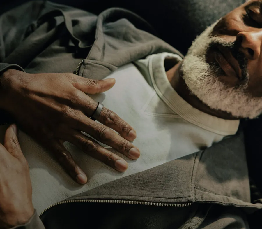 Sleeping man wearing an Oura Ring